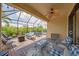 Relaxing screened-in patio showcasing outdoor furniture and lighting at 10450 Highland Park Pl, Palmetto, FL 34221