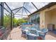 Enclosed patio boasts hot tub, dining set, and lots of greenery for a relaxing retreat at 10450 Highland Park Pl, Palmetto, FL 34221