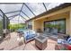 Inviting screened-in patio with comfortable seating and an outdoor fire pit at 10450 Highland Park Pl, Palmetto, FL 34221
