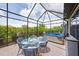 Enclosed patio featuring a dining set, hot tub, and plenty of room to lounge at 10450 Highland Park Pl, Palmetto, FL 34221