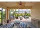 Screened-in patio featuring a ceiling fan, string lights, and comfortable seating arrangements at 10450 Highland Park Pl, Palmetto, FL 34221