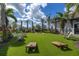 Outdoor recreation area with cornhole game, lounge chairs, and well manicured lawns at 10450 Highland Park Pl, Palmetto, FL 34221