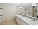 This bathroom includes dual sinks, a large mirror and decorative lighting at 111 E Early St, Brooksville, FL 34601