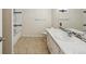 The bathroom features tile flooring and a vanity with a tile countertop and dual sinks at 111 E Early St, Brooksville, FL 34601