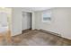 This is a carpeted bedroom with a window, a baseboard heater and a walk-in closet at 111 E Early St, Brooksville, FL 34601