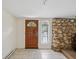 Inviting entryway with tile flooring, wood door, and stone accents to the side at 111 E Early St, Brooksville, FL 34601