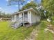 Charming single-story home featuring a white exterior with stone accents at 111 E Early St, Brooksville, FL 34601
