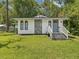 Charming single-story home with stone accents, gray front door, and a well-maintained lawn at 111 E Early St, Brooksville, FL 34601