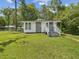 Charming single-story home with stone accents, gray front door, and a well-maintained lawn at 111 E Early St, Brooksville, FL 34601