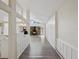 Hallway view into living room and kitchen, light flooring, and bright sunlight at 111 E Early St, Brooksville, FL 34601