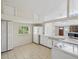 Bright kitchen featuring white cabinets and tile countertops in a well-lit home at 111 E Early St, Brooksville, FL 34601