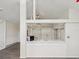 Bright kitchen with white cabinets, sink, and view to the living room at 111 E Early St, Brooksville, FL 34601