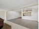 Open-concept living room with gray tile floors and seamless transition to the kitchen area at 111 E Early St, Brooksville, FL 34601