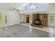 Open-concept living space with stone fireplace, light floors, and lots of natural light at 111 E Early St, Brooksville, FL 34601