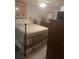Bedroom featuring a wood bed frame, dresser, overhead fan, and light gray plank flooring at 12133 Spartan Way # 203, Hudson, FL 34667