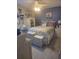 Lovely bedroom with decorative pillows, overhead fan, and light gray plank flooring at 12133 Spartan Way # 203, Hudson, FL 34667