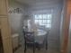 Cozy dining area with a round table set near a bright window and white storage unit at 12133 Spartan Way # 203, Hudson, FL 34667