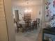 Dining room with chandelier, table with seating for eight, and hardwood flooring at 12133 Spartan Way # 203, Hudson, FL 34667