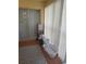 Enclosed lanai with sliding glass doors, tiled floor, and vertical blinds for adjustable light control at 12133 Spartan Way # 203, Hudson, FL 34667