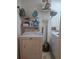 Functional laundry room with a washing machine and dryer, and shelving to hold laundry supplies at 12133 Spartan Way # 203, Hudson, FL 34667