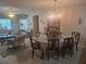 Open concept living and dining area featuring hardwood floors and a large window for natural light at 12133 Spartan Way # 203, Hudson, FL 34667