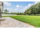 Expansive backyard featuring a well-maintained lawn, privacy fence, and a brick-paved patio perfect for outdoor enjoyment at 12251 Duckett Ct, Spring Hill, FL 34610