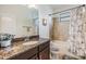 Bathroom features a granite vanity, bathtub, and shower with decorative floral arrangement at 12251 Duckett Ct, Spring Hill, FL 34610
