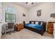 Cozy bedroom featuring a comfortable daybed, large window, and a dedicated desk area at 12251 Duckett Ct, Spring Hill, FL 34610