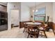 Eat in kitchen with dark cabinets, granite counters, and stainless steel appliances, and a door that leads to a laundry room at 12251 Duckett Ct, Spring Hill, FL 34610
