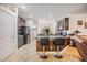 Open concept kitchen featuring a breakfast bar with seating, granite counters, and views of other rooms in the house at 12251 Duckett Ct, Spring Hill, FL 34610