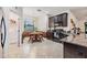 Eat in kitchen with dark cabinets, granite counters, and stainless steel appliances, and a door that leads to a laundry room at 12251 Duckett Ct, Spring Hill, FL 34610