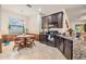 Eat in kitchen with dark cabinets, granite counters, and stainless steel appliances, and a window that overlooks the front yard at 12251 Duckett Ct, Spring Hill, FL 34610