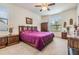 Bedroom showcasing unique wood carved furniture and a plush purple bedspread at 12251 Duckett Ct, Spring Hill, FL 34610