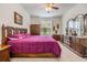 Spacious primary bedroom featuring an attractive bed set, natural light and a ceiling fan at 12251 Duckett Ct, Spring Hill, FL 34610