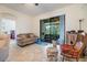 Bright living room with a view of a covered outdoor patio and lush backyard at 12251 Duckett Ct, Spring Hill, FL 34610