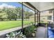 Enjoy outdoor living in this screened porch with a spacious backyard view and comfortable seating at 12251 Duckett Ct, Spring Hill, FL 34610