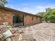 Spacious brick home deck with outdoor seating areas to enjoy lush green backyard at 12603 Corral Rd, Tampa, FL 33626