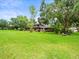 Expansive backyard with well-manicured lawn and mature trees at 12603 Corral Rd, Tampa, FL 33626