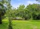 Lush backyard with pond featuring fountain and mature trees at 12603 Corral Rd, Tampa, FL 33626