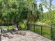 Patio overlooking the backyard's lush greenery and tranquil pond at 12603 Corral Rd, Tampa, FL 33626