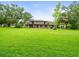 Expansive backyard with lush green grass and brick home at 12603 Corral Rd, Tampa, FL 33626