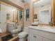 Elegant bathroom with marble walls, gold framed mirrors, and a walk-in shower at 12603 Corral Rd, Tampa, FL 33626