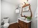 Bathroom with vintage wooden vanity, white vessel sink, and traditional light fixture at 12603 Corral Rd, Tampa, FL 33626