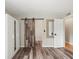 Bedroom with rustic barn door, a wardrobe, and neutral tones at 12603 Corral Rd, Tampa, FL 33626