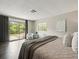 Bedroom with dark wood floors, sliding glass doors to the deck, and neutral decor at 12603 Corral Rd, Tampa, FL 33626