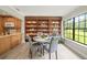 Well-lit dining area with hardwood floors, built-in shelving, and a large window at 12603 Corral Rd, Tampa, FL 33626
