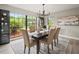 Beautifully staged dining room with backyard views, modern light fixtures, and minimalist décor at 12603 Corral Rd, Tampa, FL 33626