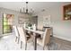 Charming dining room with a modern chandelier, neutral color palette, and beautiful art at 12603 Corral Rd, Tampa, FL 33626