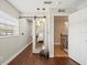 Hallway featuring hardwood floors, mirror, and a view of the stairway at 12603 Corral Rd, Tampa, FL 33626