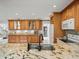 The kitchen features custom wood cabinets, granite countertops, and modern appliances at 12603 Corral Rd, Tampa, FL 33626